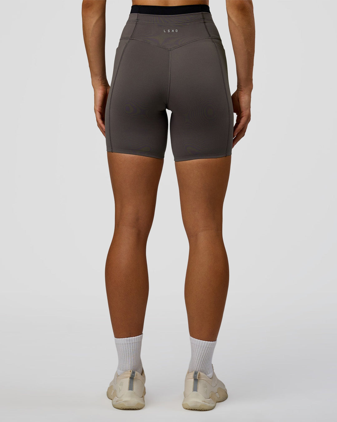 Woman wearing Liberate High-Rise 6" Short Pockets in Duskstone-Black | Model:Maja | Size:XS