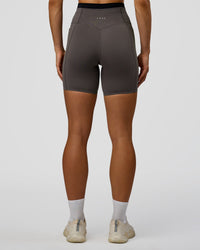 Woman wearing Liberate High-Rise 6" Short Pockets in Duskstone-Black | Model:Maja | Size:XS