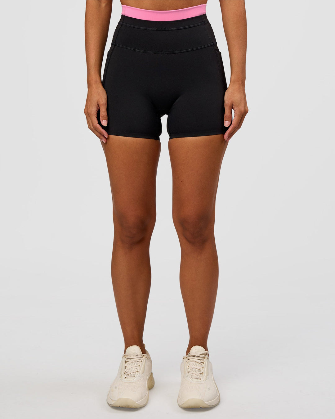 Woman wearing Liberate High-Rise 4" Short Pockets - Black-Candy Pink | Model:Brylee | Size:XS