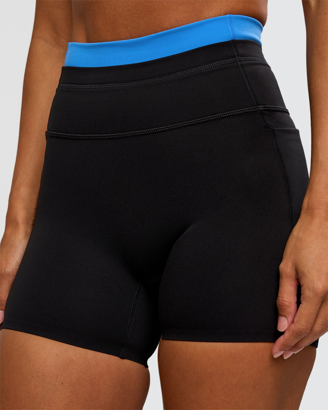 Woman wearing Liberate High-Rise 4" Short Pockets - Black-Palace Blue | Model:Brylee | Size:XS