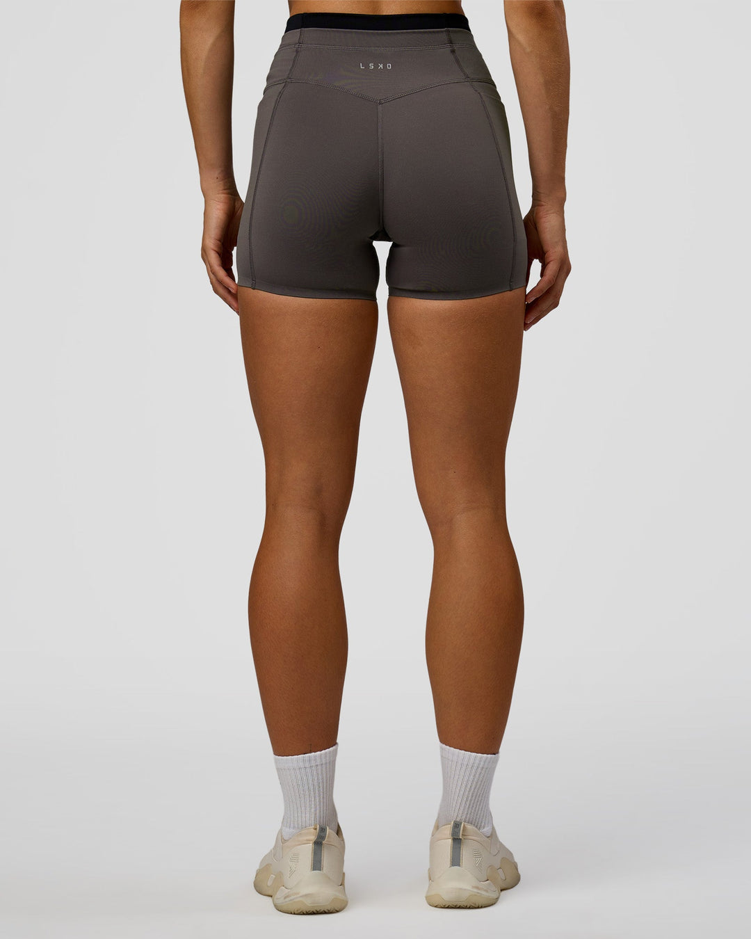 Woman wearing Liberate High-Rise 4" Short Pockets in Duskstone-Black | Model:Maja | Size:XS