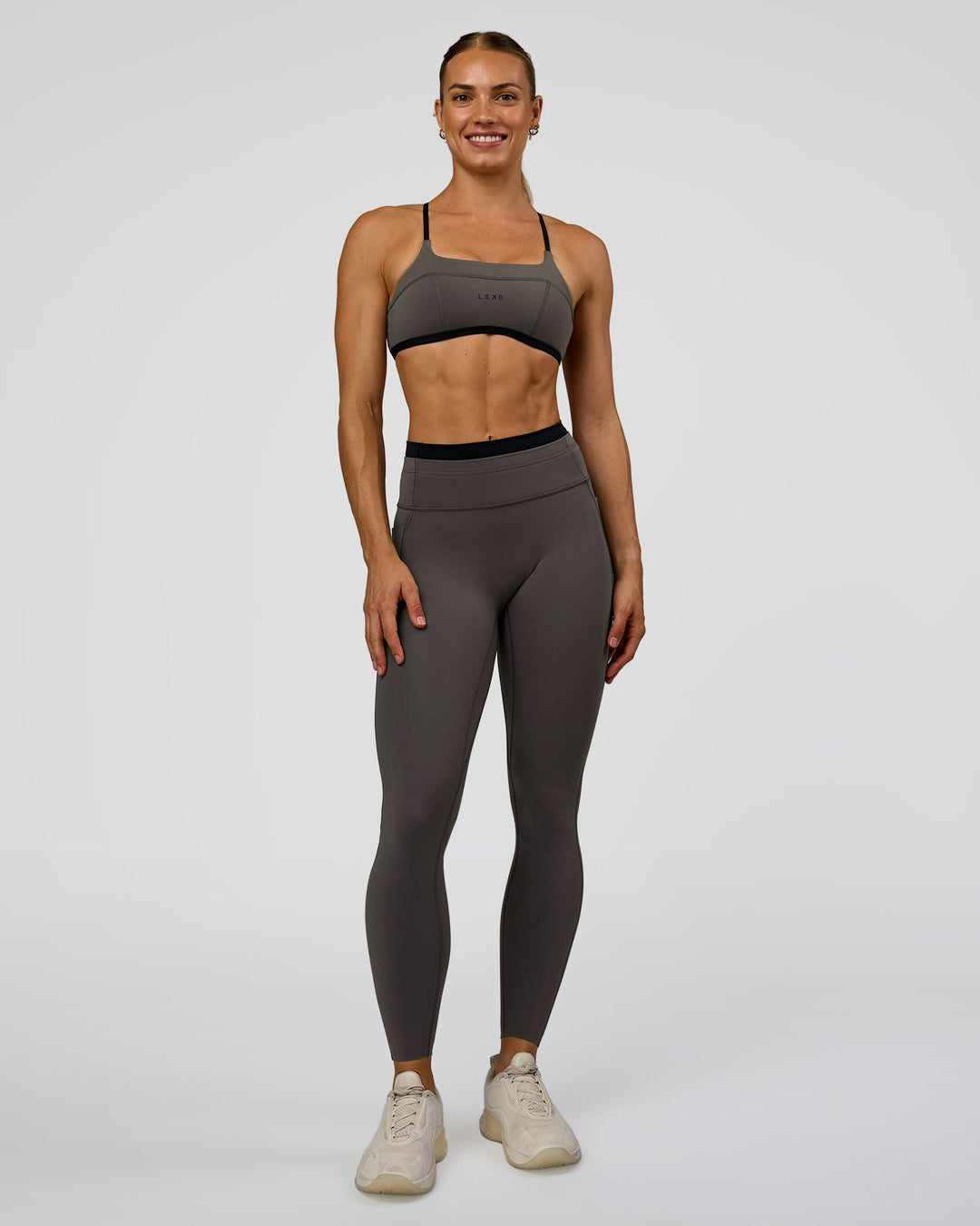 Woman wearing Liberate Sports Bra in Duskstone-Black | Model:Maja | Size:XS