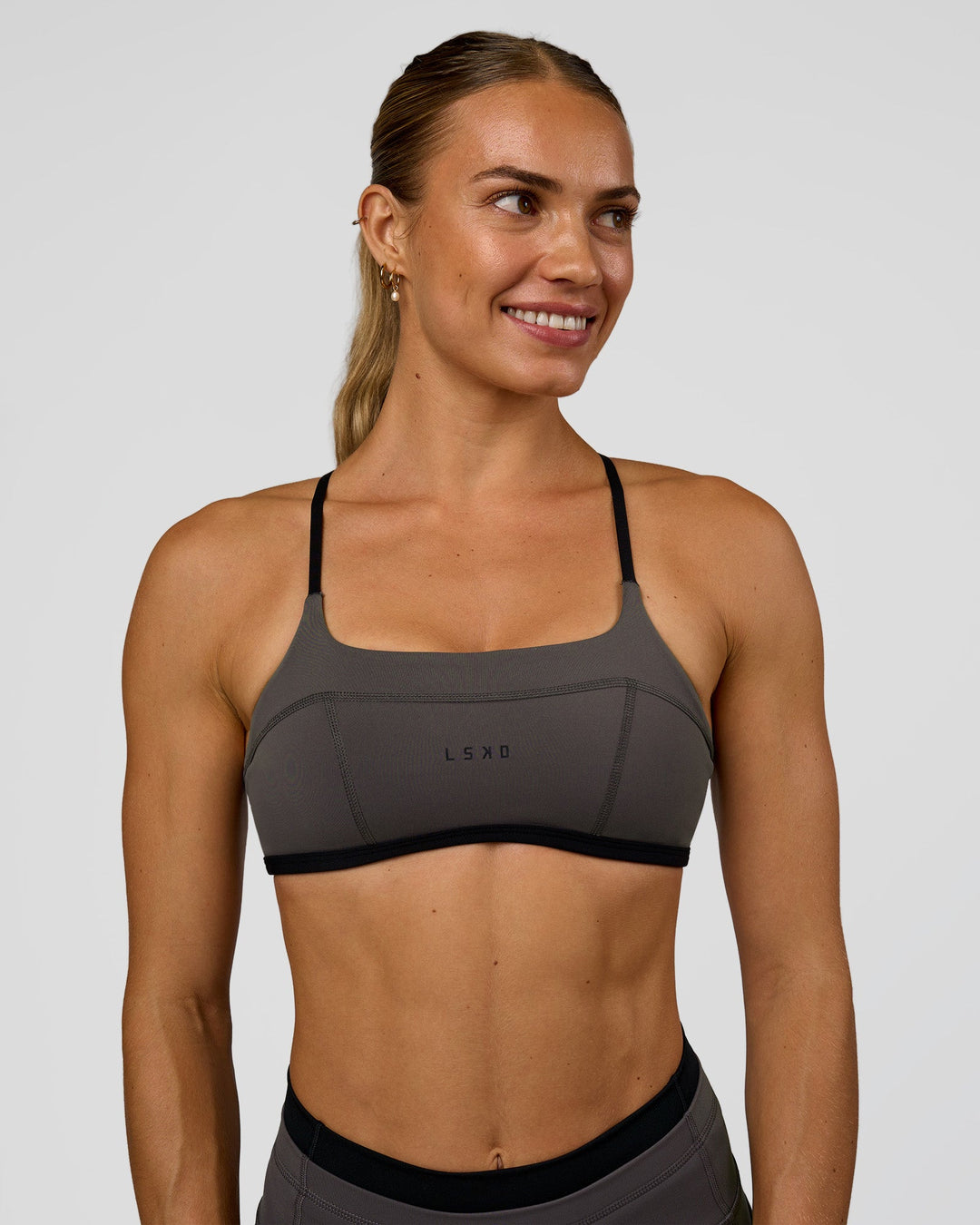 Woman wearing Liberate Sports Bra in Duskstone-Black | Model:Maja | Size:XS