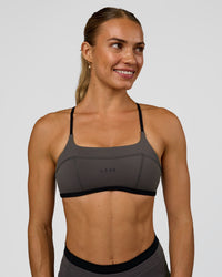 Woman wearing Liberate Sports Bra in Duskstone-Black | Model:Maja | Size:XS