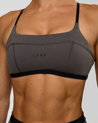 Woman wearing Liberate Sports Bra in Duskstone-Black | Model:Maja | Size:XS