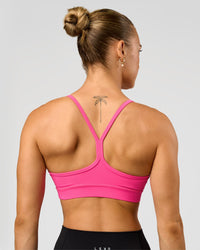 Woman wearing Lift Sports Bra - Ultra Pink | Model:Maja | Size:XS