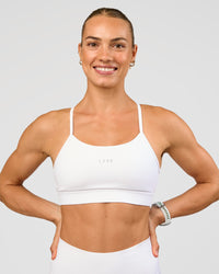 Woman wearing Lift Sports Bra - White | Model:Maja | Size:XS