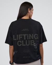 Woman wearing Lifting Club FLXCotton Tee Oversize - Black-Black | Model:Rhiley | Size:XS