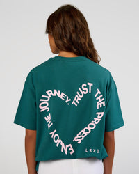 Woman wearing Love The Process FLXCotton Oversize Tee - Transformative Teal-Marshmallow | Model:Dakota | Size:XS