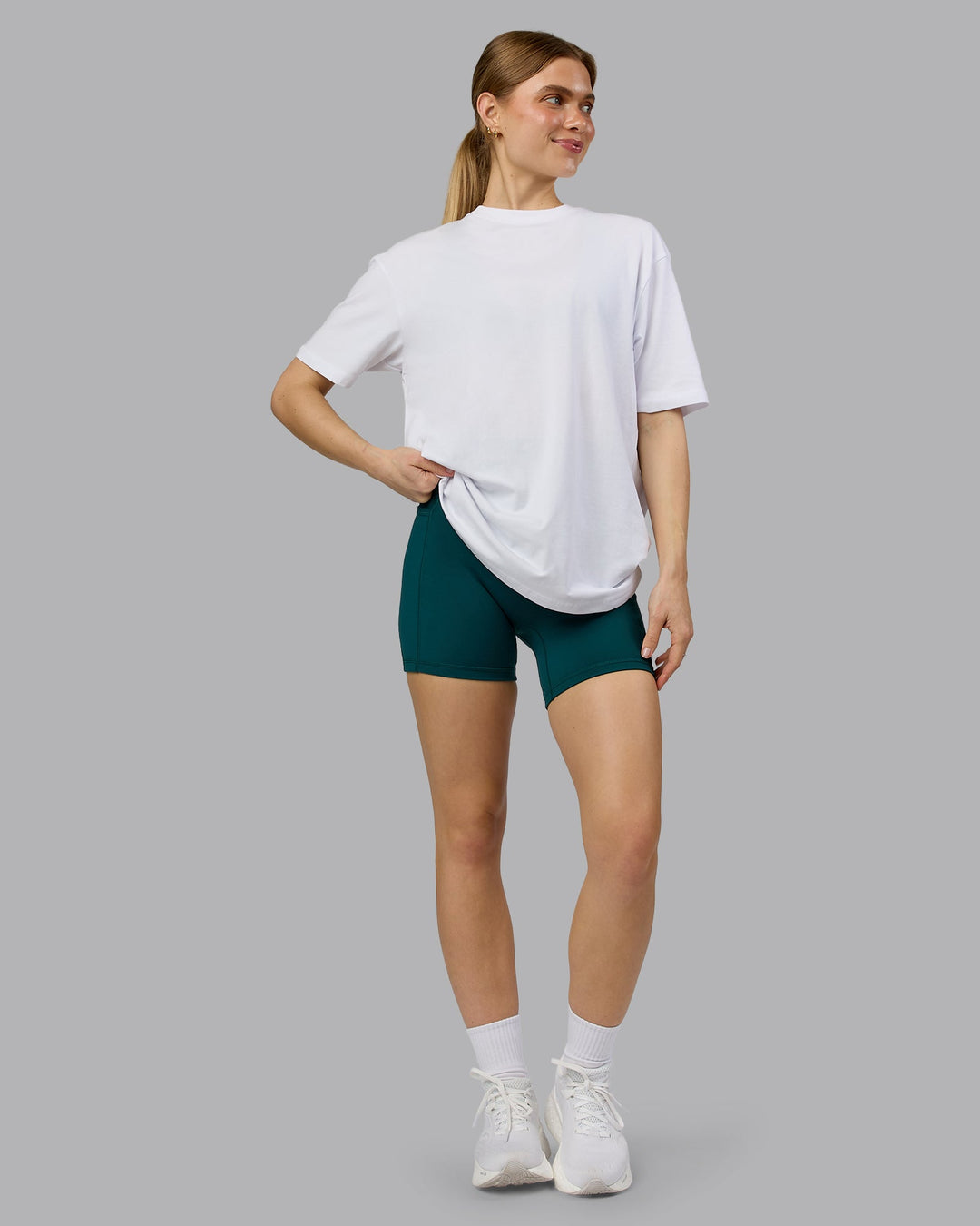 Woman wearing Love The Run FLXCotton Tee Oversize - White-Dark Moss | Model:Emilie | Size:XS