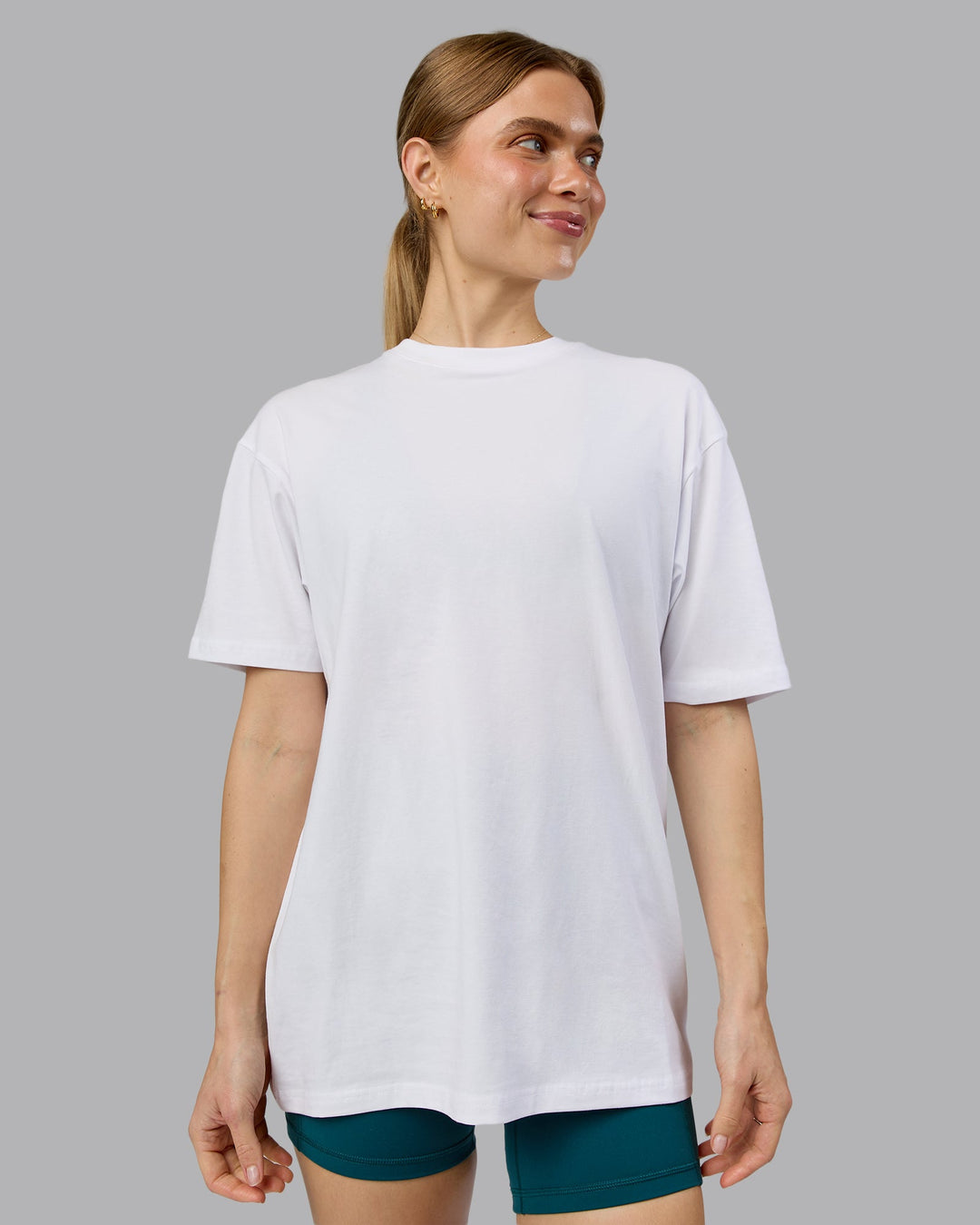 Woman wearing Love The Run FLXCotton Tee Oversize - White-Dark Moss | Model:Emilie | Size:XS