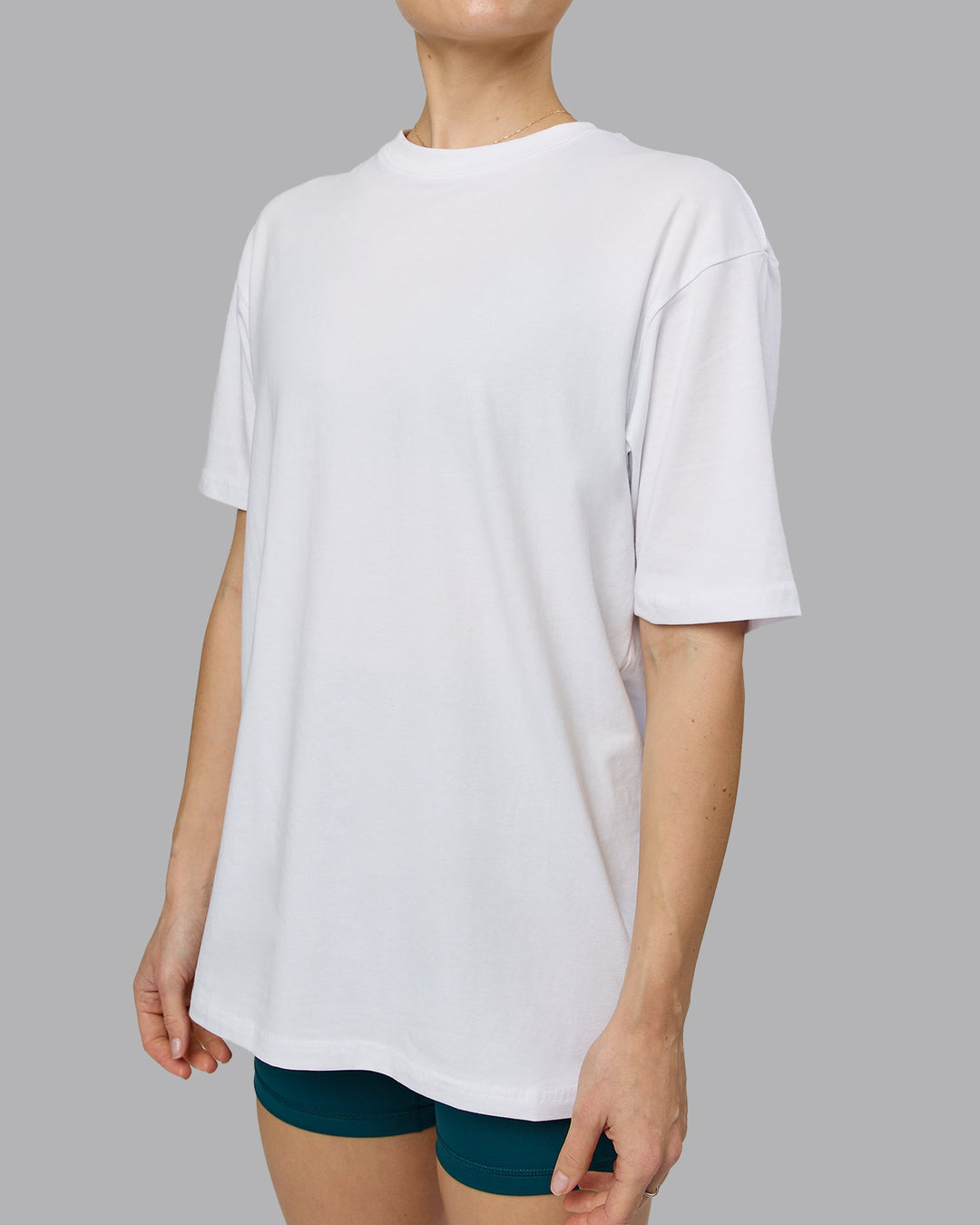 Woman wearing Love The Run FLXCotton Tee Oversize - White-Dark Moss | Model:Emilie | Size:XS