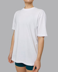 Woman wearing Love The Run FLXCotton Tee Oversize - White-Dark Moss | Model:Emilie | Size:XS