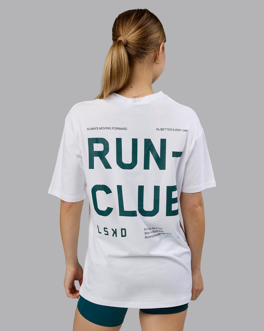 Woman wearing Love The Run FLXCotton Tee Oversize - White-Dark Moss | Model:Emilie | Size:XS