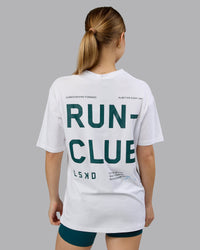 Woman wearing Love The Run FLXCotton Tee Oversize - White-Dark Moss | Model:Emilie | Size:XS