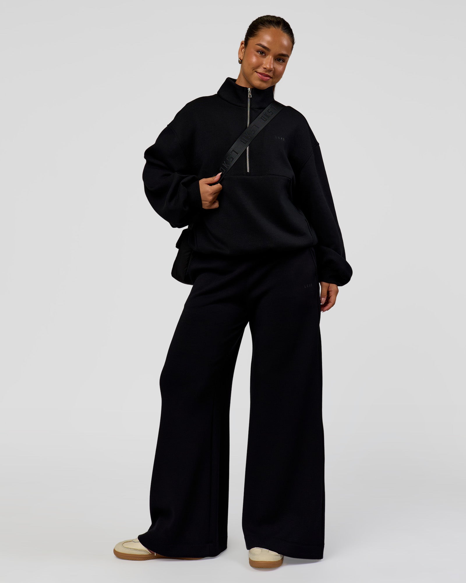 Woman wearing Luxe ZeroCrease Spacer Half Zip - Black | Model:Sophia | Size:XS