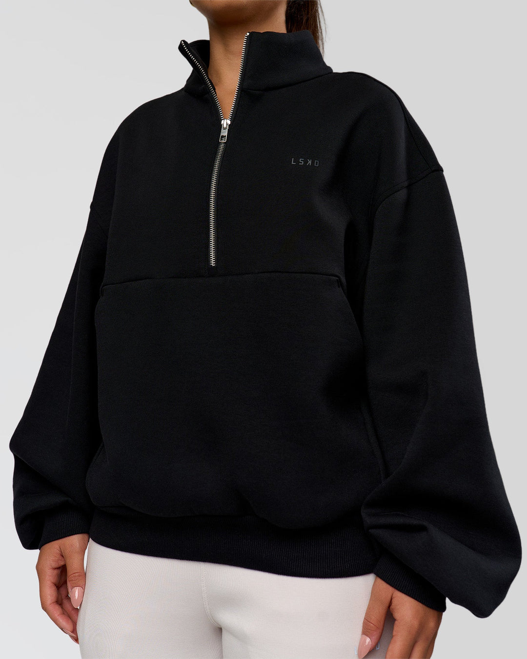 Woman wearing Luxe ZeroCrease Spacer Half Zip - Black | Model:Sophia | Size:XS