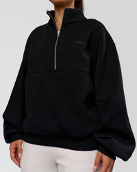 Woman wearing Luxe ZeroCrease Spacer Half Zip - Black | Model:Sophia | Size:XS