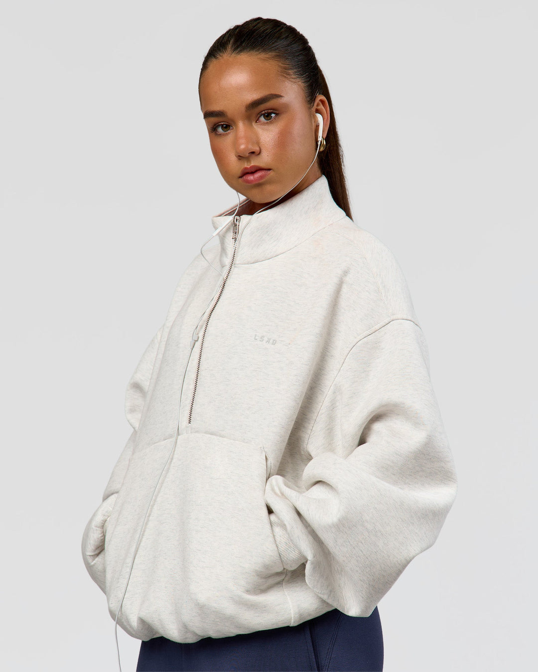 Woman wearing Luxe ZeroCrease Spacer Half Zip - Silver Marl | Model:Sophia | Size:XS