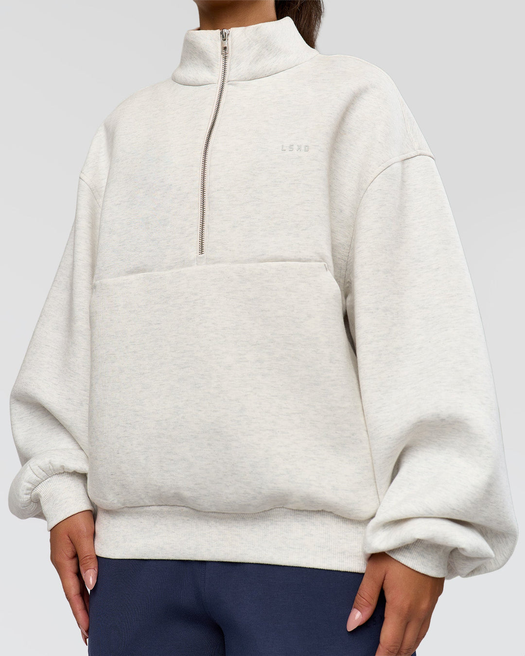 Woman wearing Luxe ZeroCrease Spacer Half Zip - Silver Marl | Model:Sophia | Size:XS