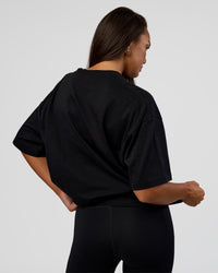 Woman wearing MVP 2.0 Oversized Tee - Black | Model:Kirstyn | Size:XS
