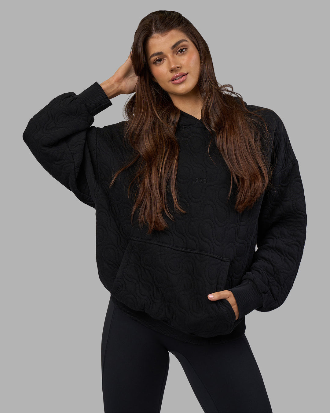 Woman wearing MVP Quilted Oversized Hoodie - Black-Geometric | Model:Phoebe | Size:XS