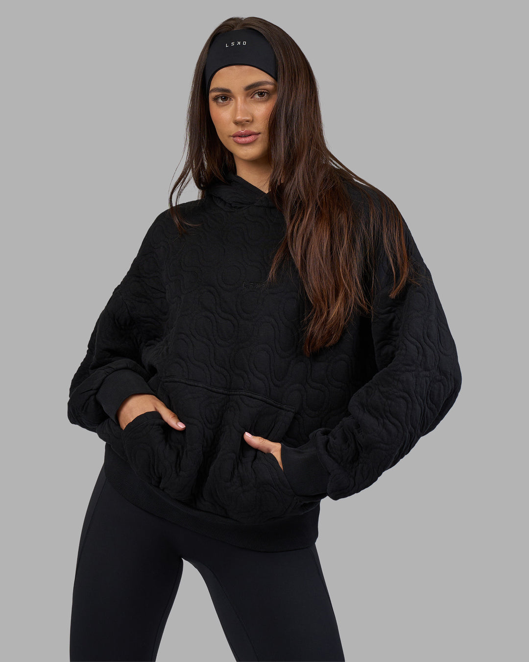 Woman wearing MVP Quilted Oversized Hoodie - Black-Geometric | Model:Phoebe | Size:XS