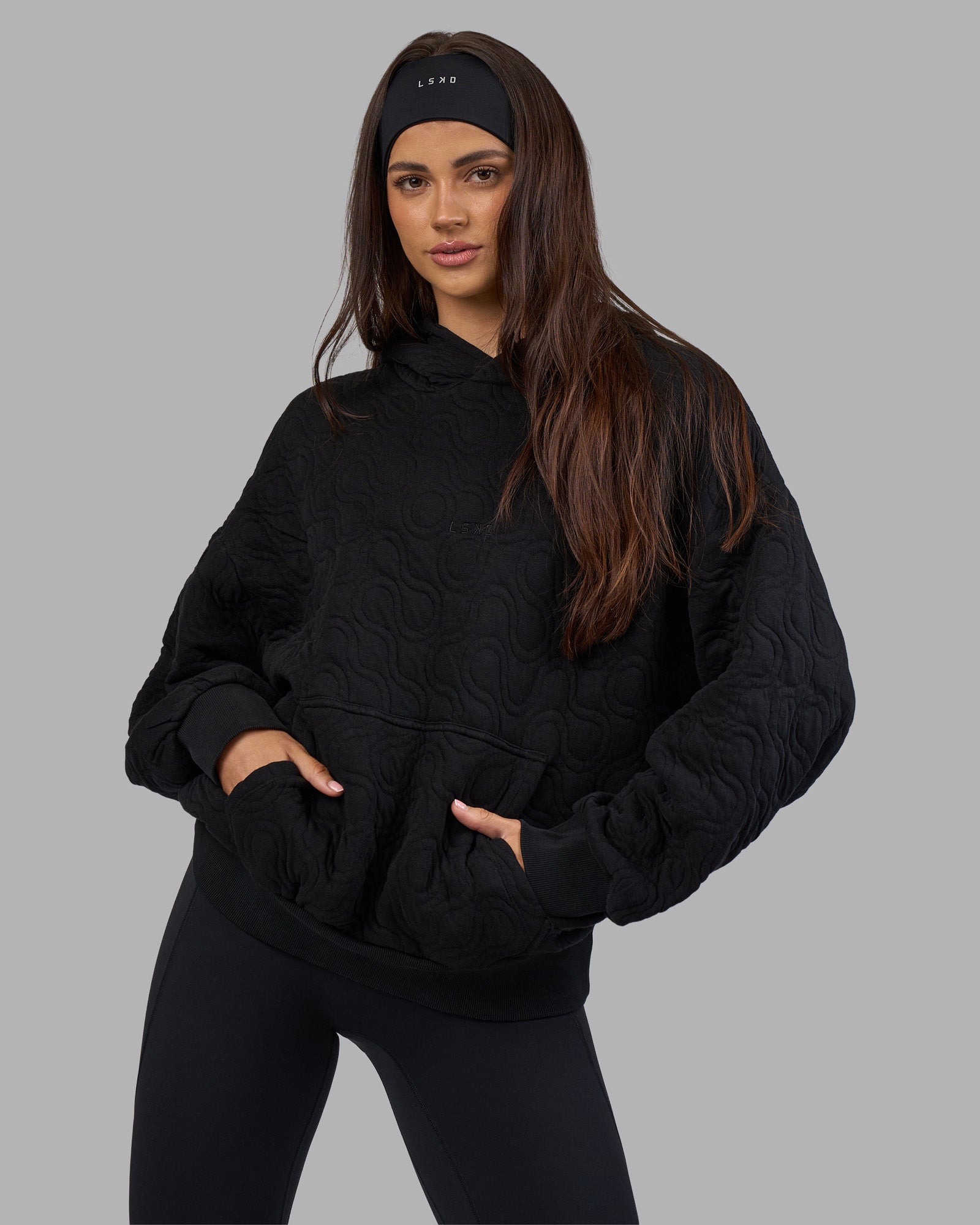Woman wearing MVP Quilted Oversized Hoodie - Black-Geometric | Model:Phoebe | Size:XS