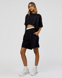 Woman wearing Memory in Motion Heavyweight Oversized Tee - Black Washed | Model:Leilani | Size:XS
