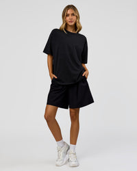Woman wearing Memory in Motion Heavyweight Oversized Tee - Black Washed | Model:Leilani | Size:XS