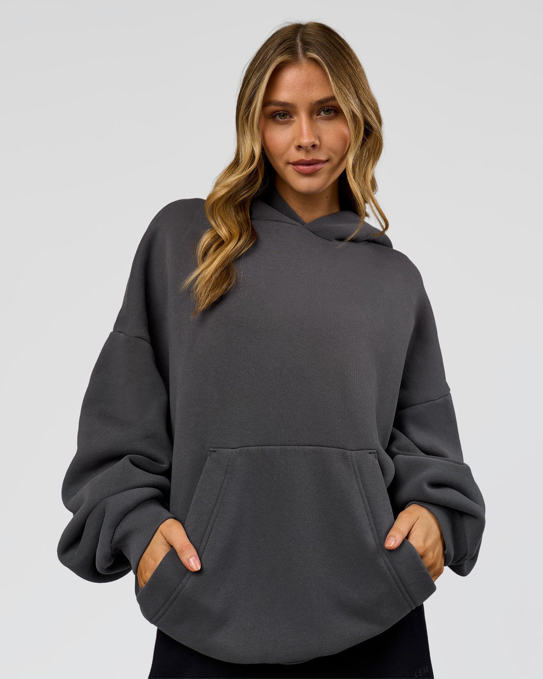 Woman wearing Memory In Motion Ultra Heavyweight Washed Hoodie - Dark Storm Washed | Model:Leilani | Size:XS