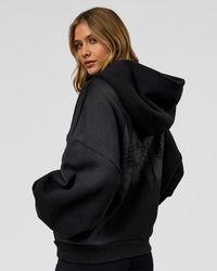 Woman wearing Memory in Motion Ultra Heavyweight Zip Thru Hoodie - Black Washed | Model:Leilani | Size:XS