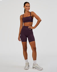 Woman wearing Momentum Corset Sports Bra - Midnight Plum | Model:Brylee | Size:XS