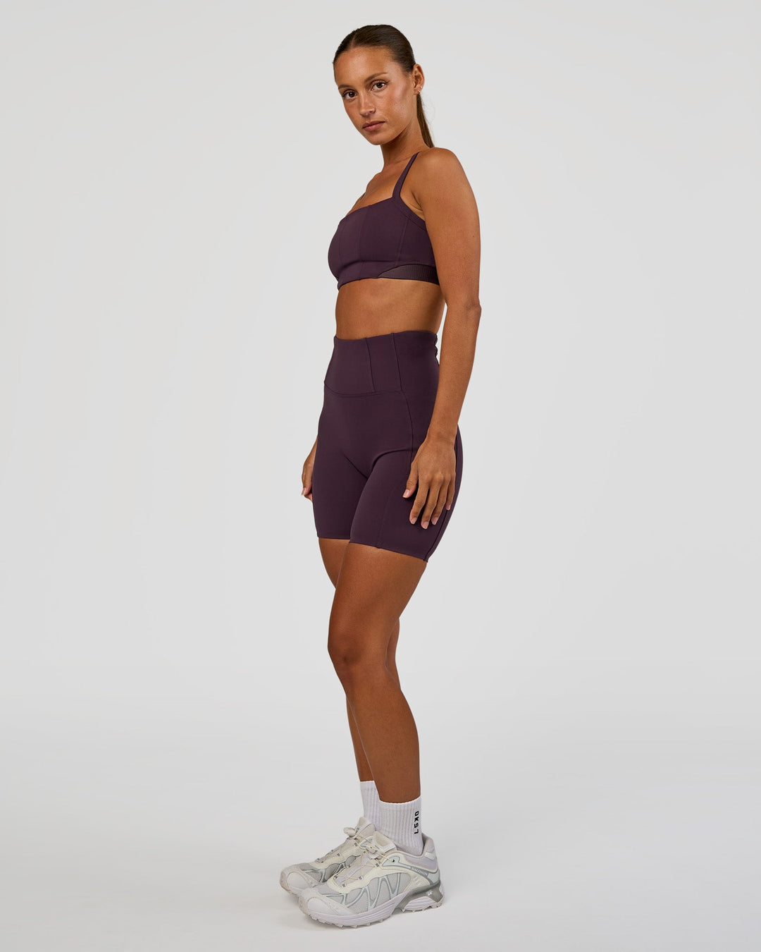 Woman wearing Momentum Corset Sports Bra - Midnight Plum | Model:Brylee | Size:XS