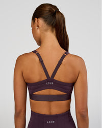 Woman wearing Momentum Corset Sports Bra - Midnight Plum | Model:Brylee | Size:XS