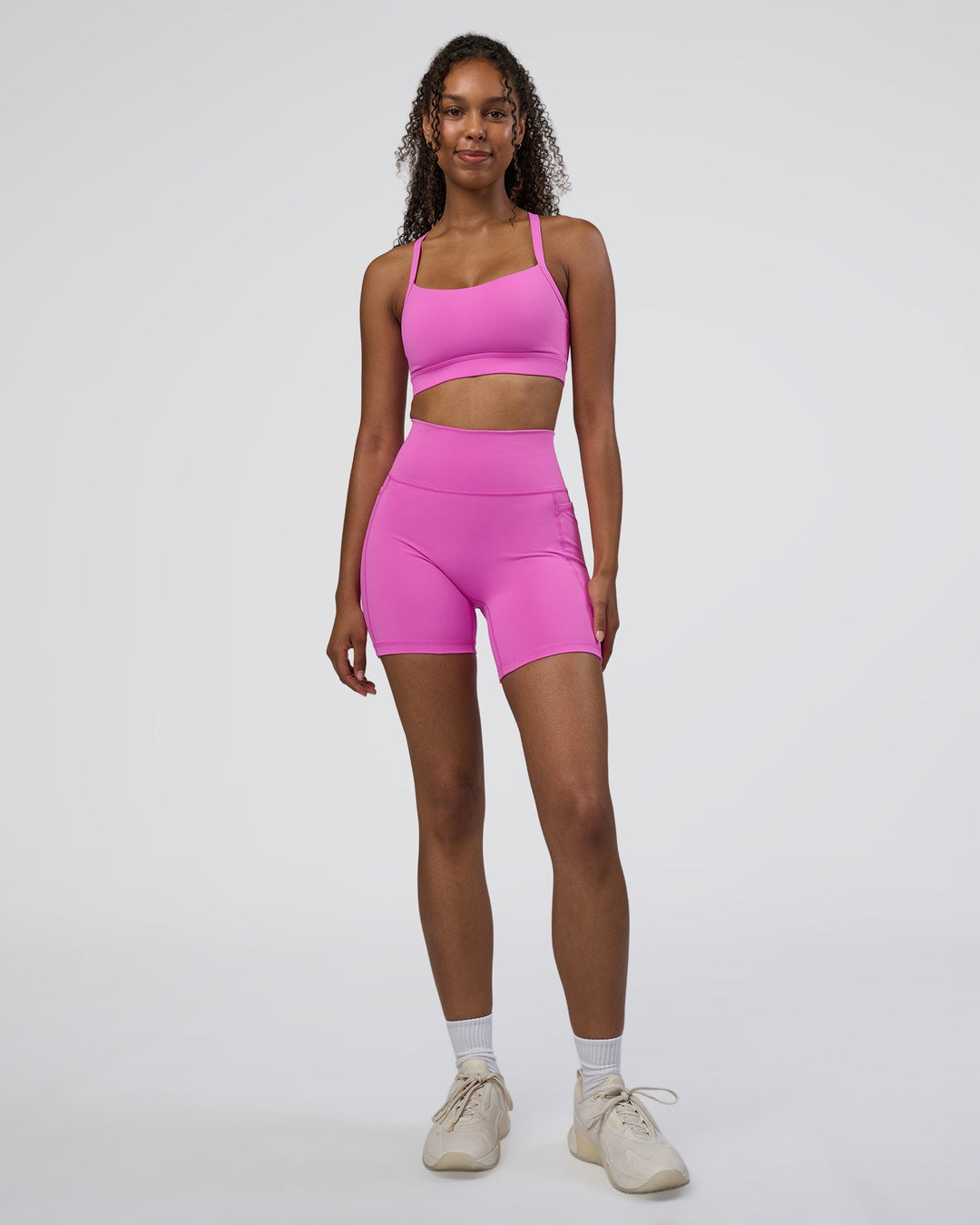 Woman wearing Momentum Sports Bra D/DD/E - Ultra Fuchsia | Model:Jordan | Size:XS