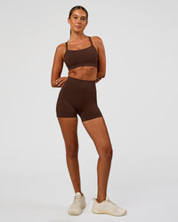 Woman wearing Momentum Sports Bra - Hot Chocolate | Model:Charli | Size:XS