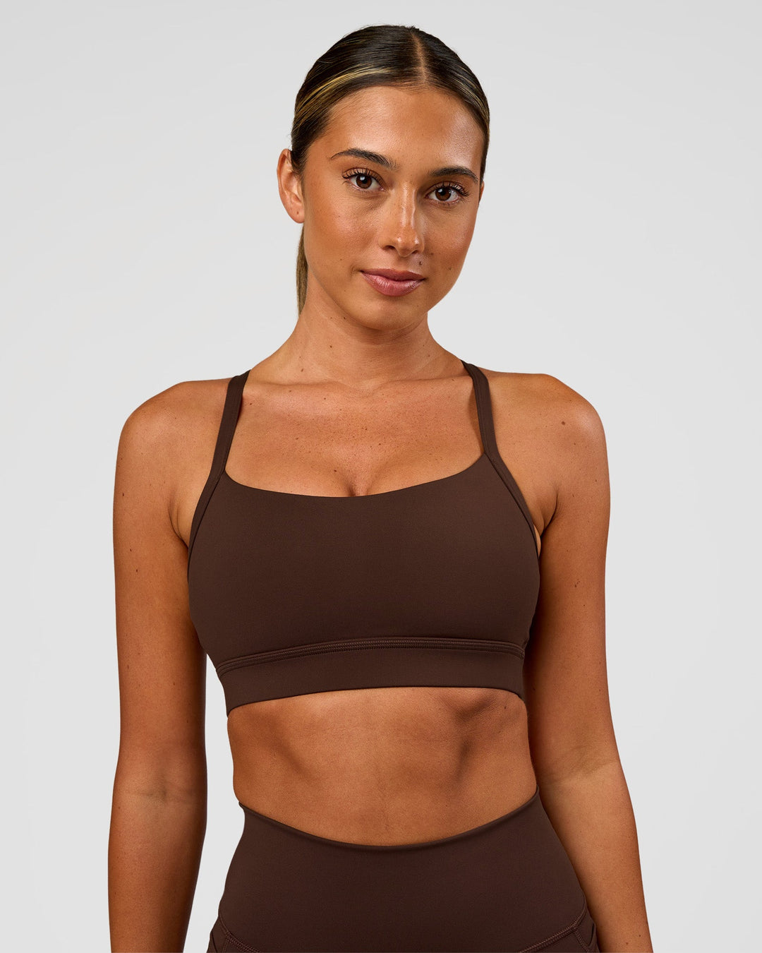 Woman wearing Momentum Sports Bra - Hot Chocolate | Model:Charli | Size:XS
