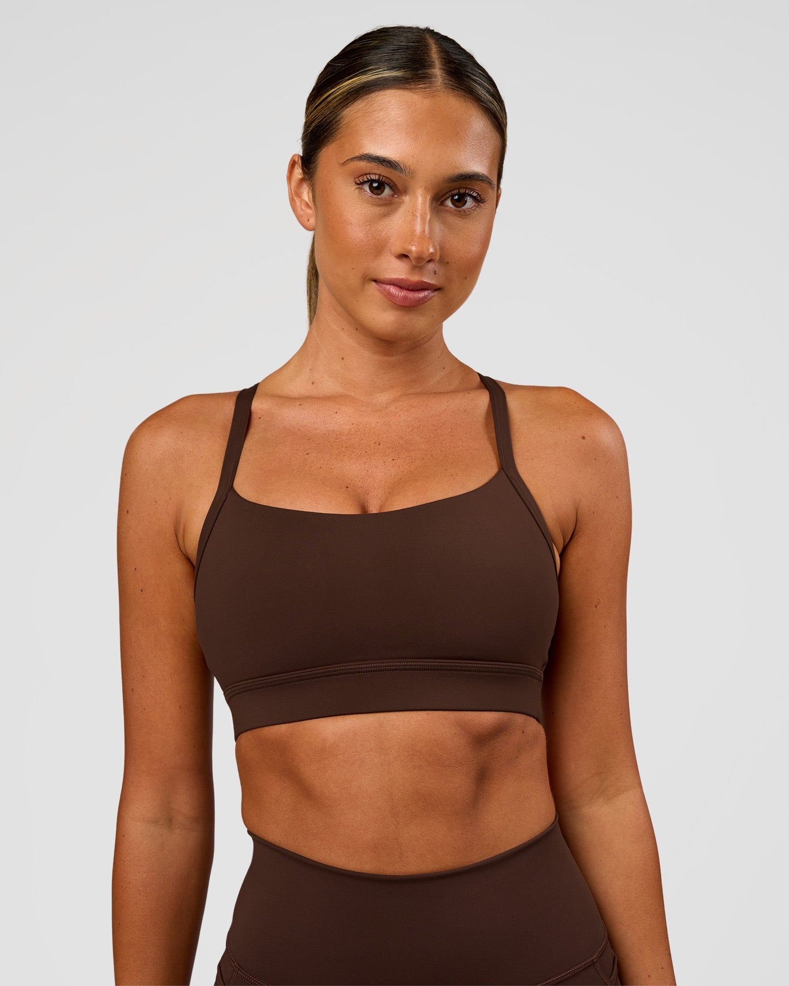 Woman wearing Momentum Sports Bra - Hot Chocolate | Model:Charli | Size:XS