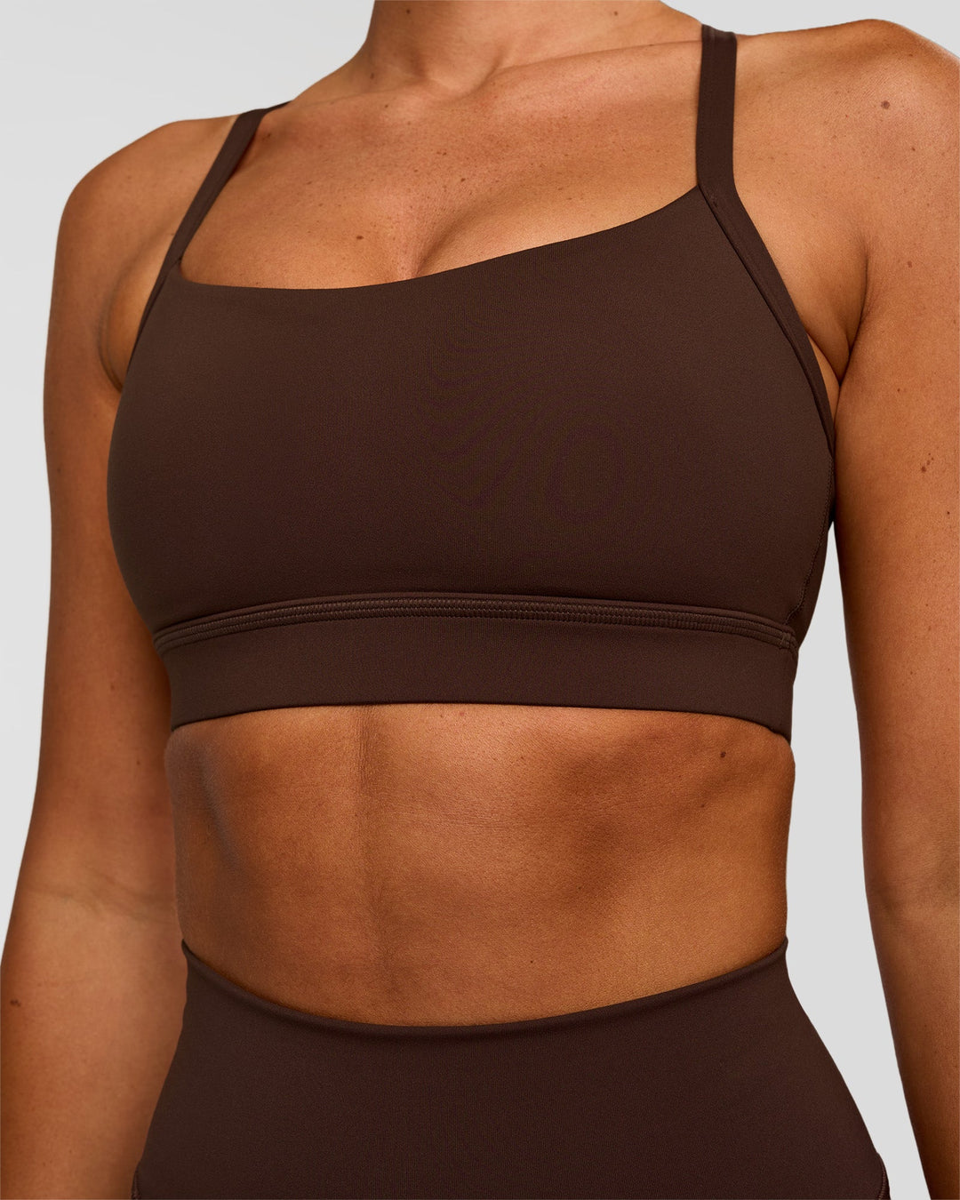 Woman wearing Momentum Sports Bra - Hot Chocolate | Model:Charli | Size:XS