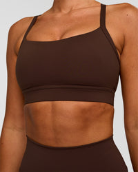 Woman wearing Momentum Sports Bra - Hot Chocolate | Model:Charli | Size:XS