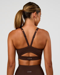 Woman wearing Momentum Sports Bra - Hot Chocolate | Model:Charli | Size:XS