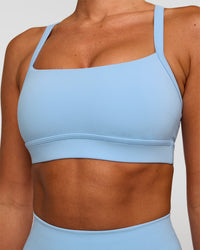 Woman wearing Momentum Sports Bra - Open Air | Model:Charli | Size:XS