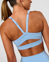 Woman wearing Momentum Sports Bra - Open Air | Model:Charli | Size:XS