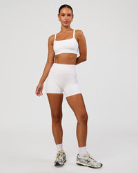 Woman wearing Momentum Sports Bra - White | Model:Brylee | Size:XS