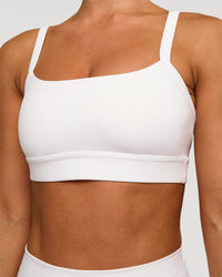 Woman wearing Momentum Sports Bra - White | Model:Brylee | Size:XS