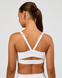 Woman wearing Momentum Sports Bra - White | Model:Brylee | Size:XS