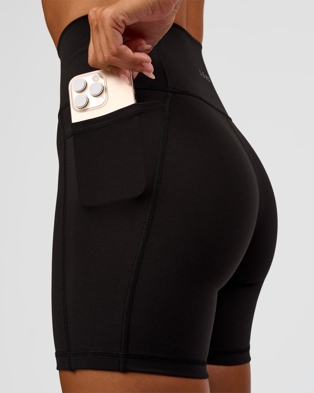 Woman wearing O.G Fusion Ultra High-Rise 6" Short Pockets - Black | Model:Charli | Size:XS