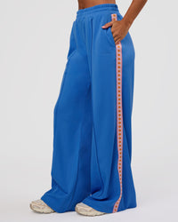 Woman wearing Peaches Track Pant - Palace Blue | Model:Brylee | Size:XS | Thumbnail Index: 6