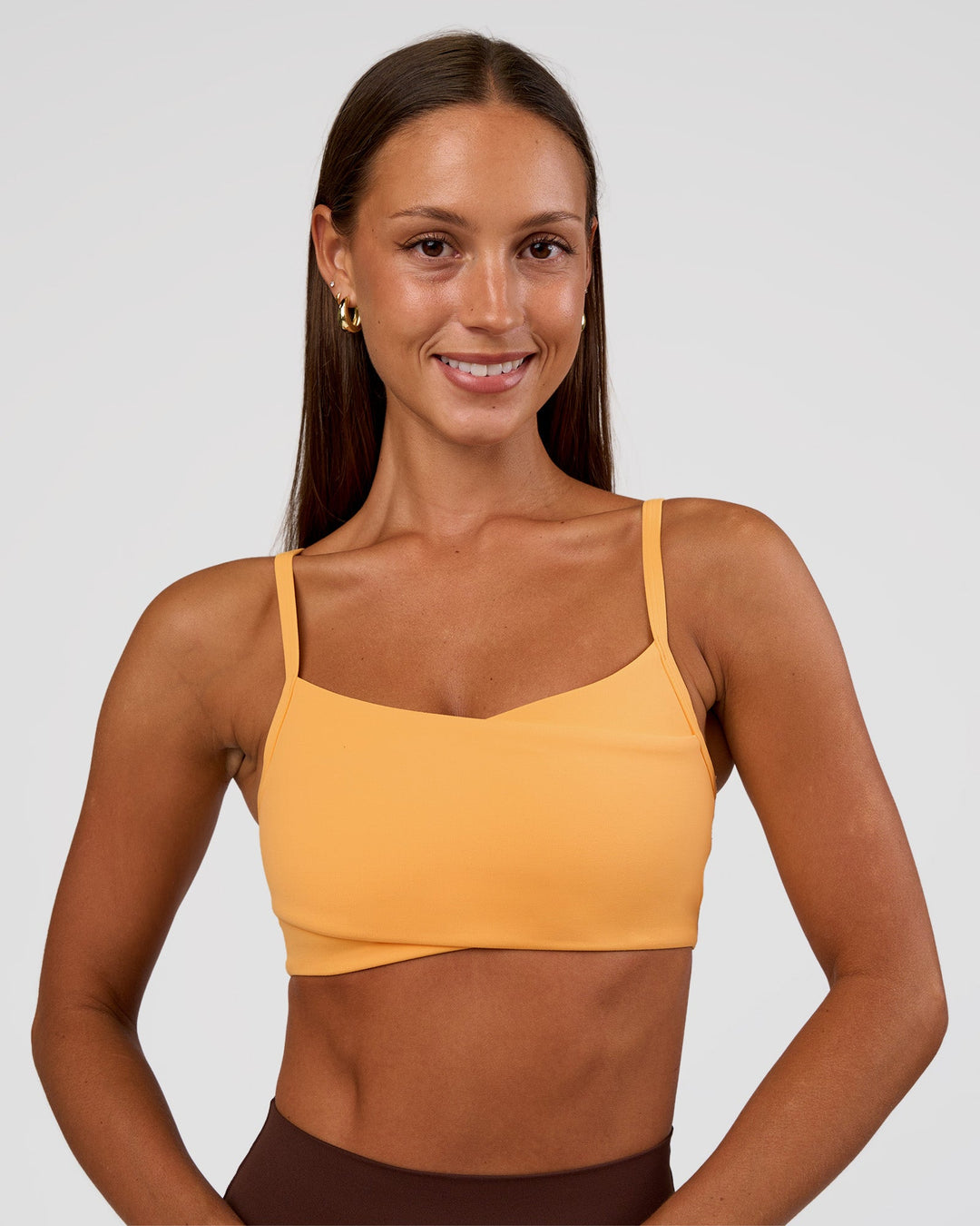Woman wearing Peaches Wrap Sports Bra - Warm Apricot | Model:Brylee | Size:XS